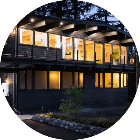 2 story house at night with lights coming through the windows