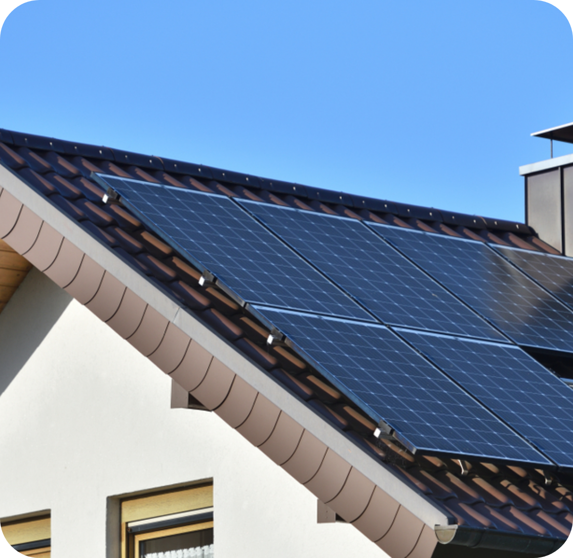 Solar panels on house with white walls and chimney