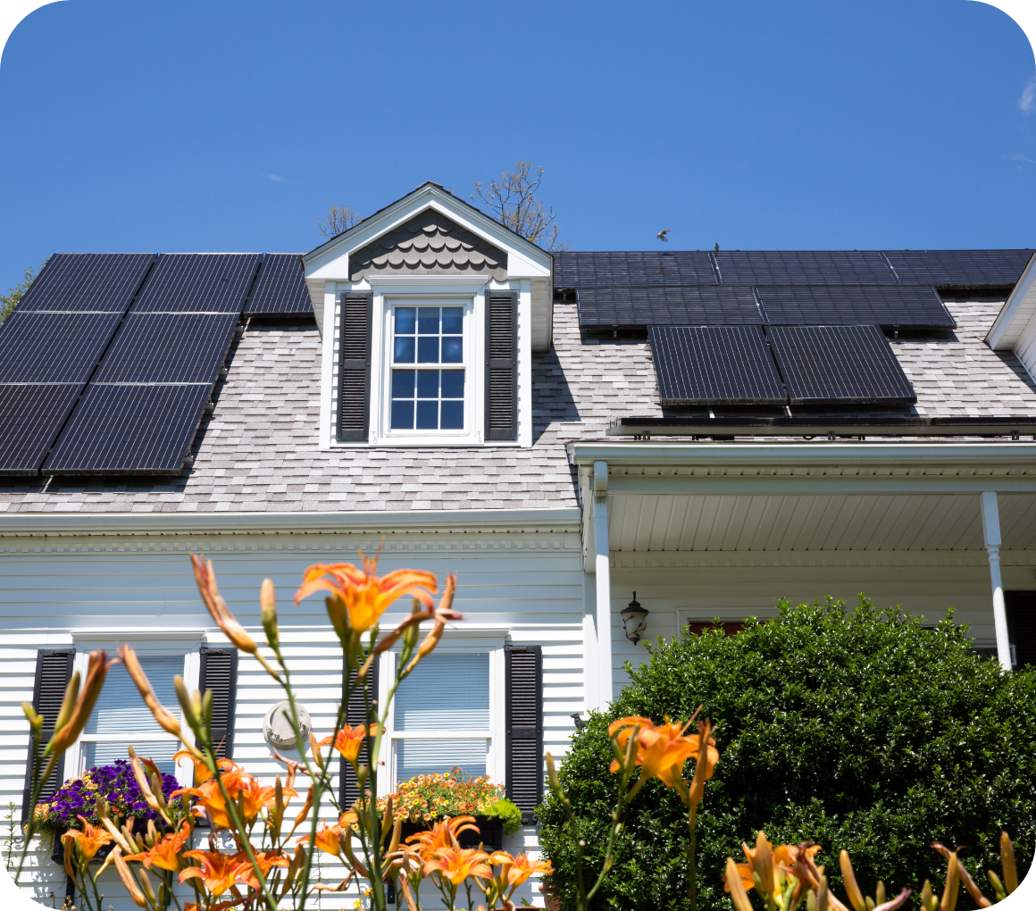 House with solar panels and orange flowers