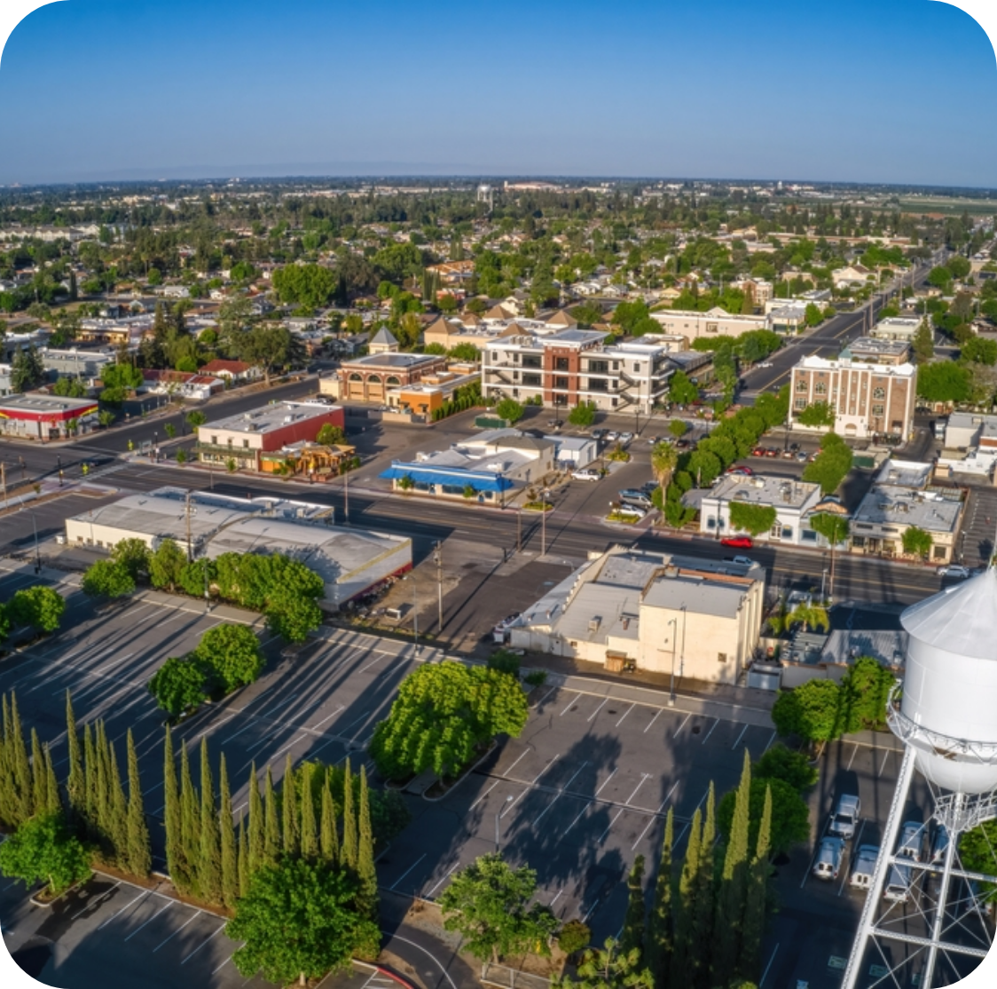 City with trees, parking lots, and a water tower