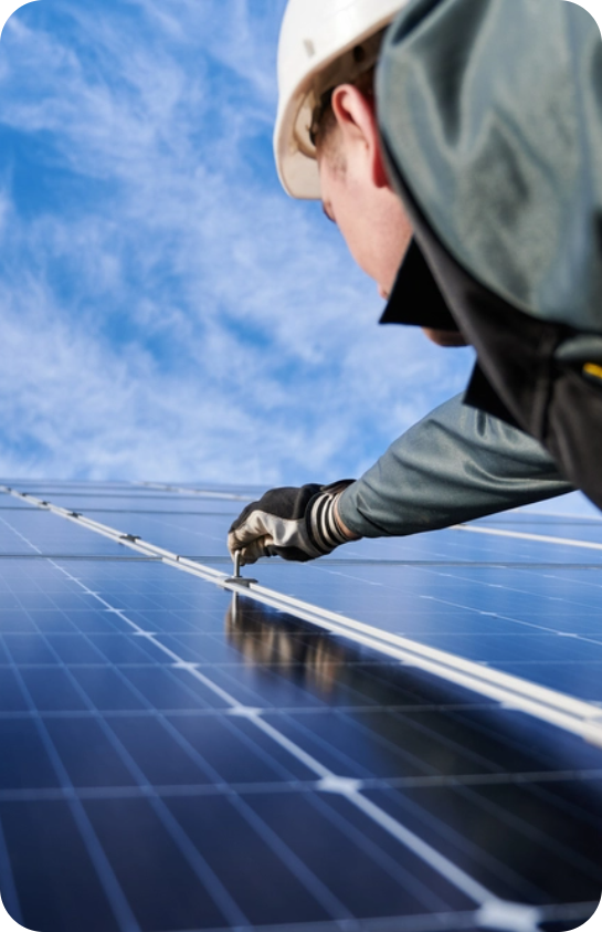 Maintenance working reaching up to work on solar panel