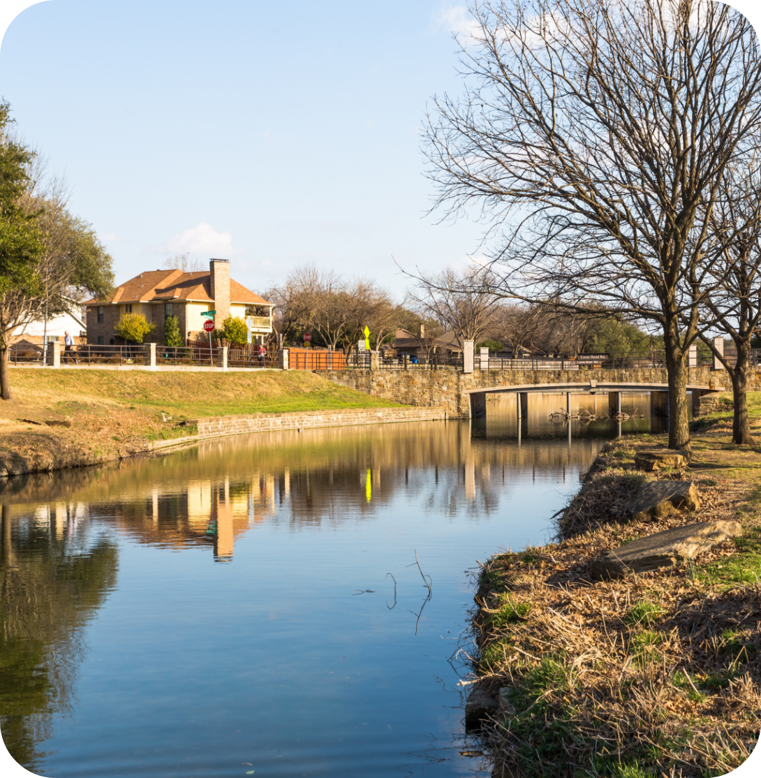 House next to a river with a bridge