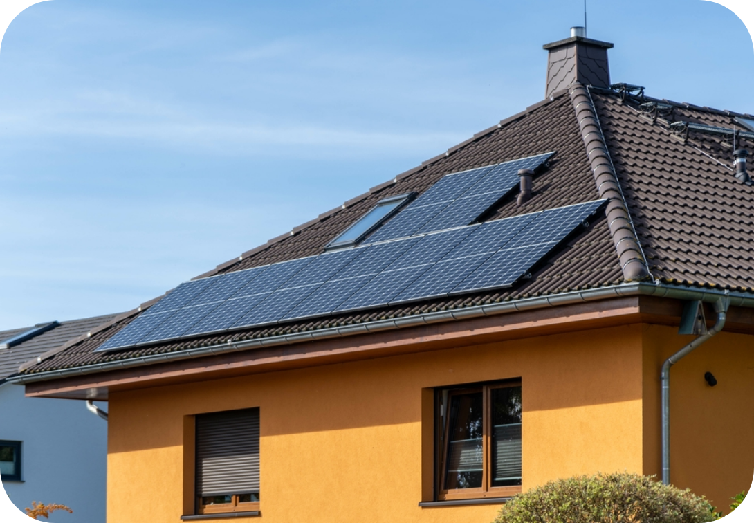 House with solar panels, yellow palls, and rounded shingles