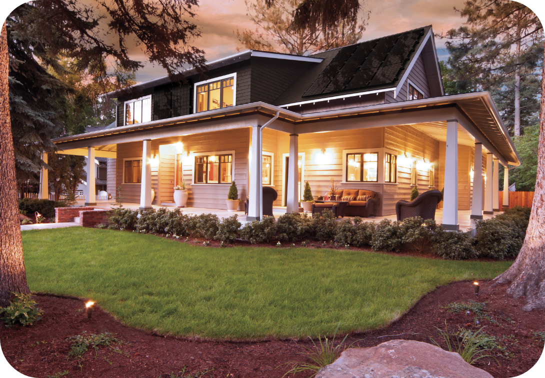 House with wrap-around porch with outside lights on