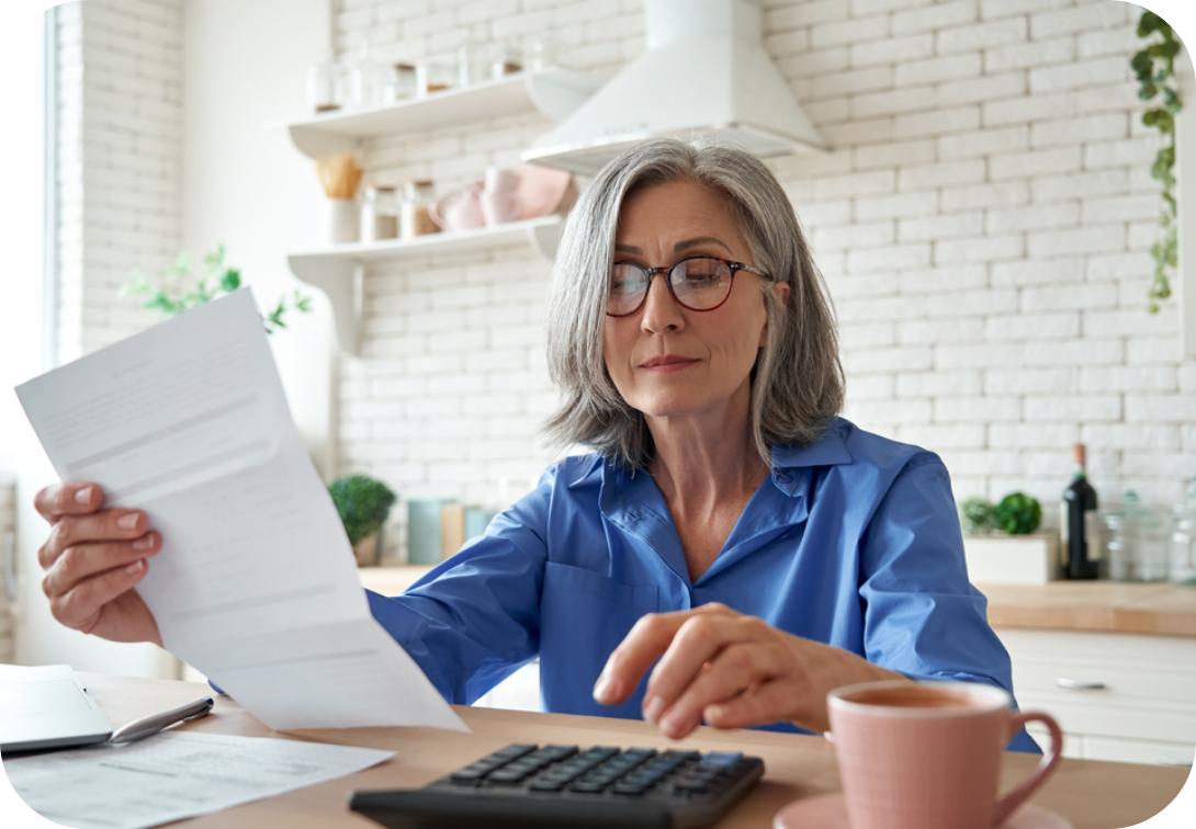 Older woman reviewing a bill with a calculator