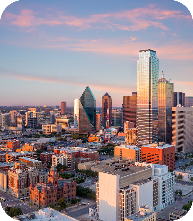 City skyline with sky scrapers and pink and blue sunset