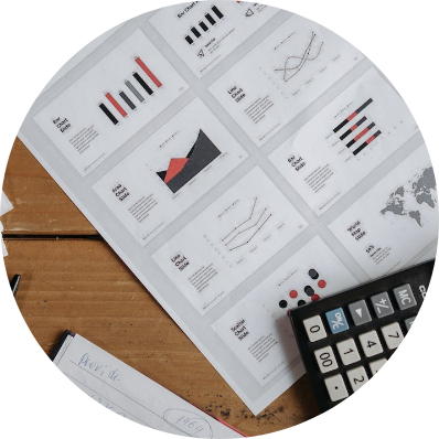 Orange and black charts on paper with calculator on top