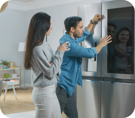 A couple using their smart fridge