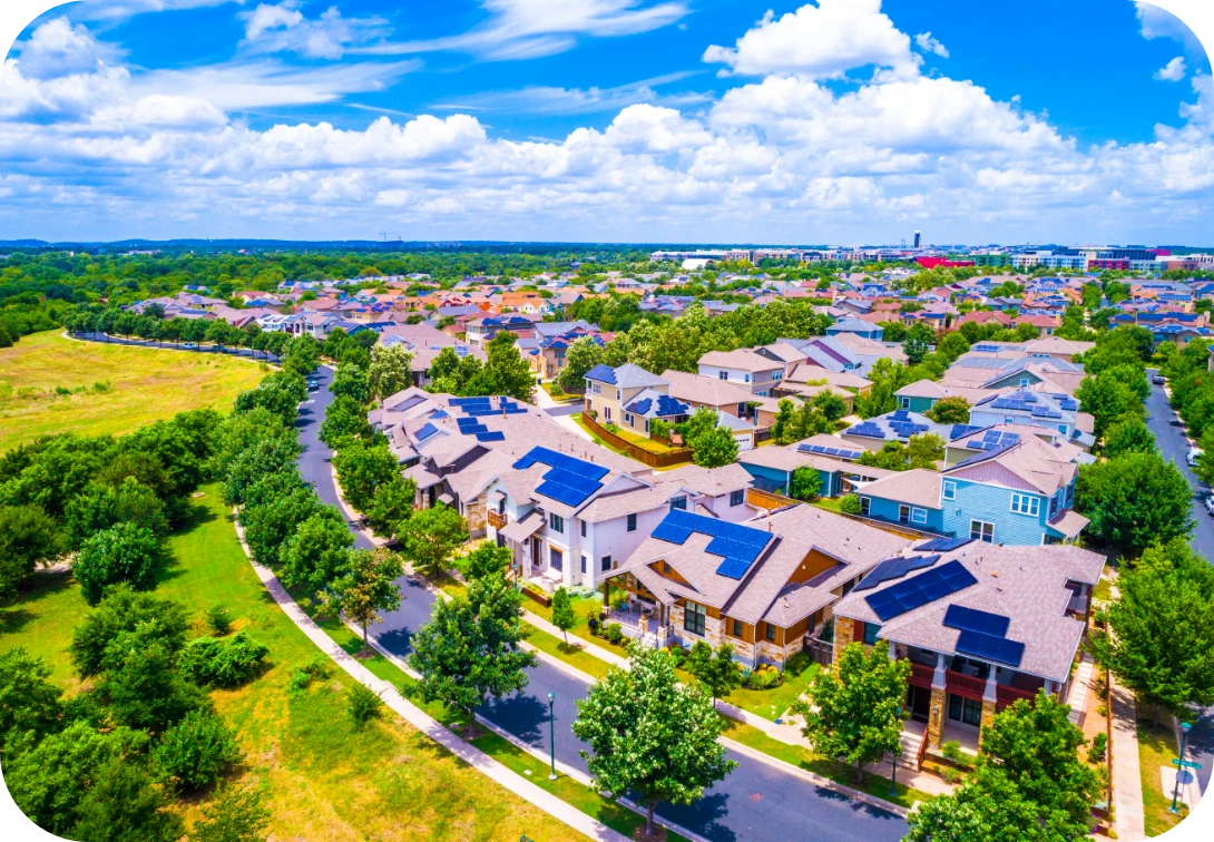 Birdseye view of multiple houses with solar panels