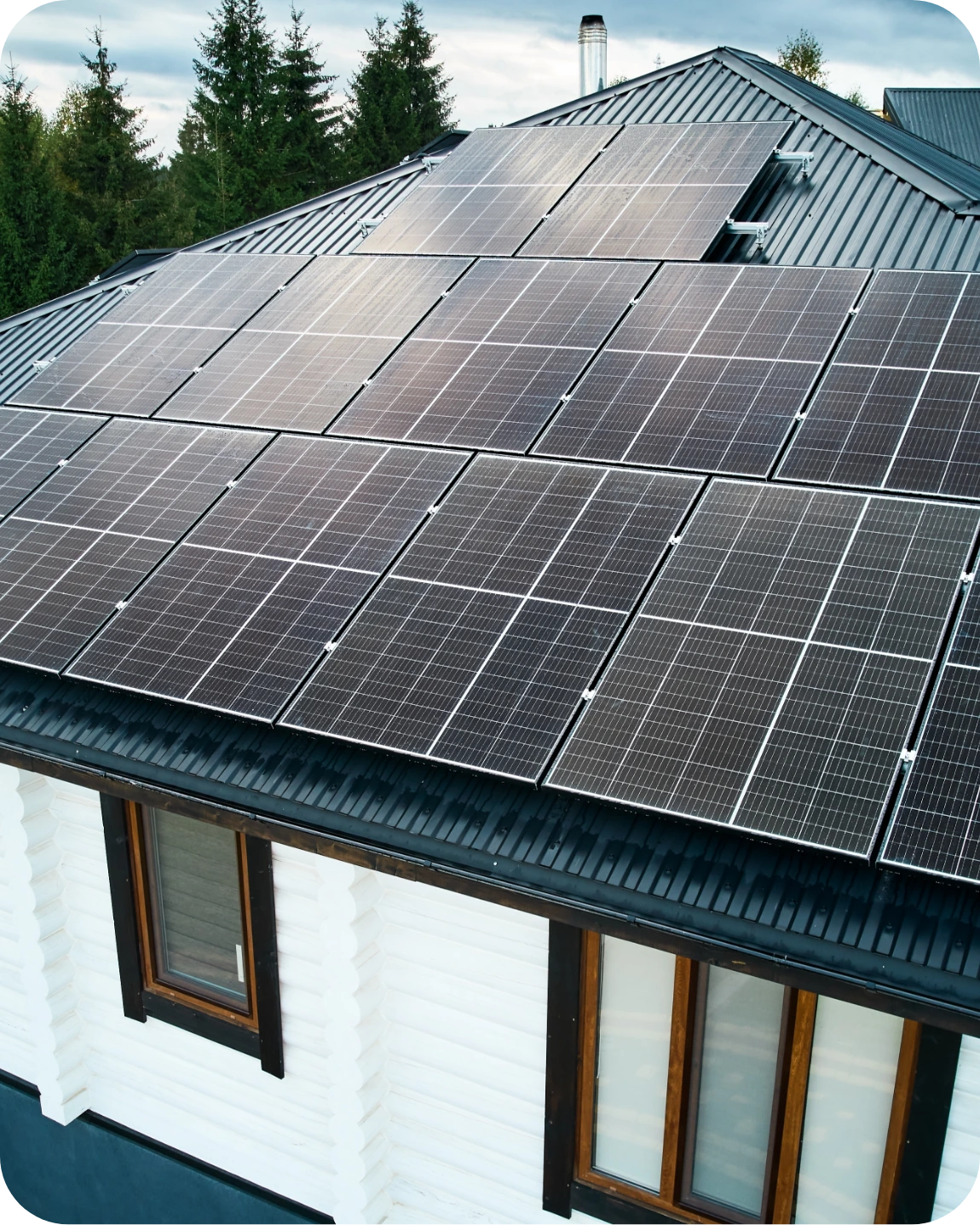 House with white log siding and solar panels